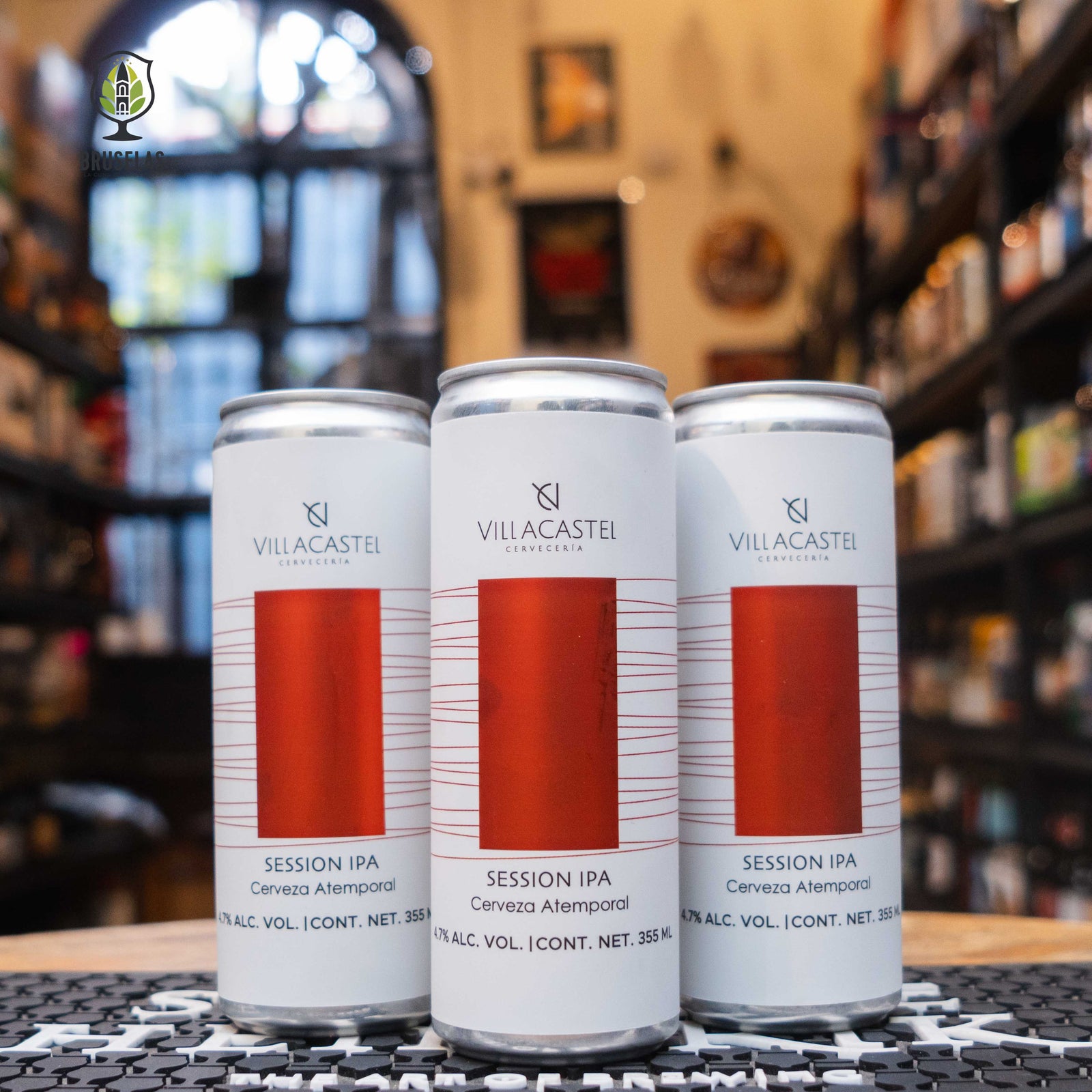 cerveza “Villacastel Session IPA” con un diseño minimalista en blanco, cerigrafia en tonos naranjas y rojisos