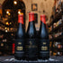 Botellas de Santa Sabina Requiem Dark Sour Barrel con frambuesa, envueltas en cera roja, exhibidas en tienda cervecera artesanal